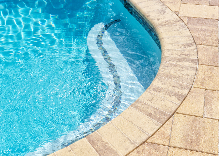 beautiful pool deck built with pavers